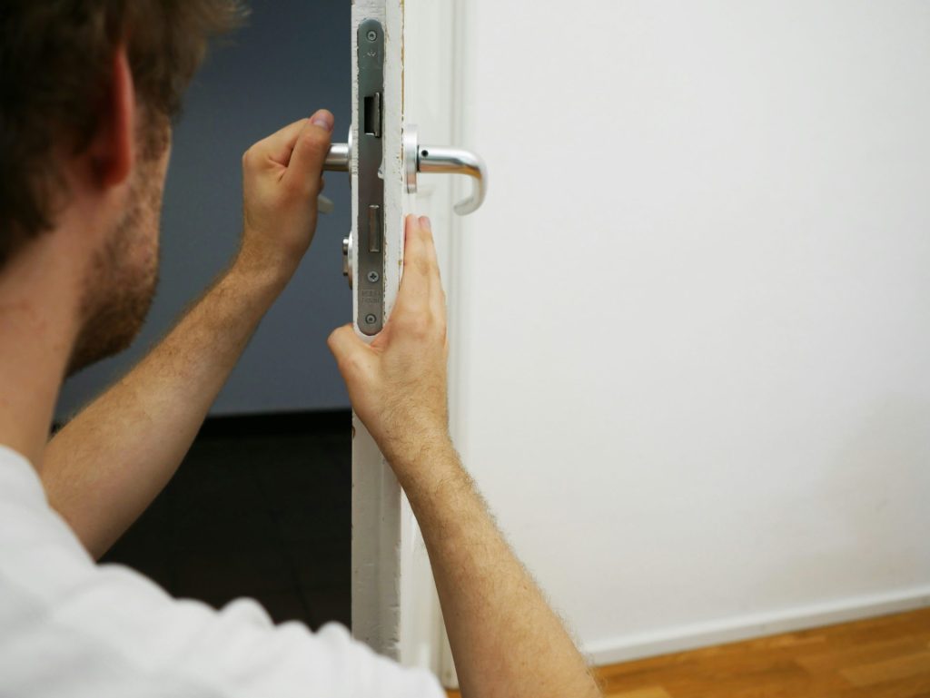 person holds door lever